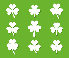 White vector clover leaves isolated on green