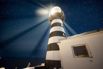 Ancient lighthouse on the background of the starry sky