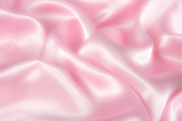 Abstract pink silk fabric texture background. Cloth soft wave. Creases of satin