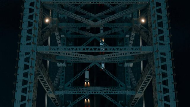 The view from above a steel-structured suspension bridge at night, looking down on the moving traffic below.