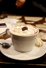 Hot chocolate with whipped cream and cacao on top. 