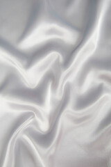 Abstract gray silk fabric texture background. Cloth soft wave. Creases of satin