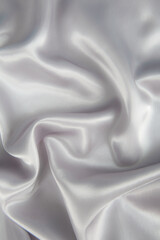 Abstract gray silk fabric texture background. Cloth soft wave. Creases of satin