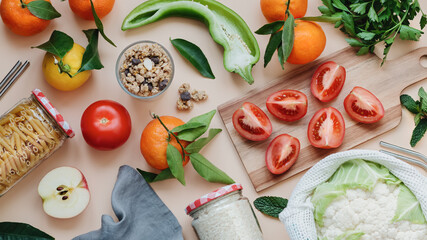 Flat lay with fresh local vegetables and fruits on neutral background, top view