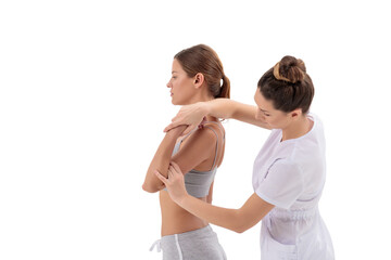 Doctor physiotherapist stretching a young sport woman isolated on a white background