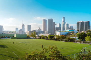 Green football field with views of downtown and high-rise buildings. Los Angeles, USA - 16 Apr 2021