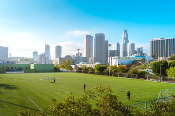 Green football field with views of downtown and high-rise buildings. Los Angeles, USA - 16 Apr 2021