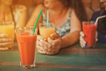 person drinking orange juice