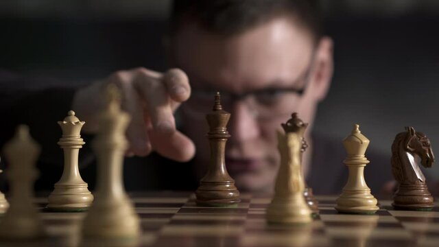 Chess and checkmate to an opponent playing chess. the opponent got checkmated and put the king on the board admitting defeat. Chess game checkmate king lies