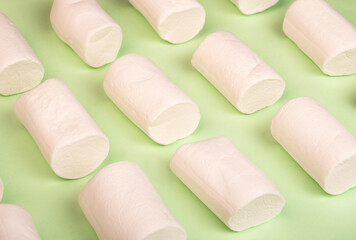 Marshmallow pattern close-up on a green background. Summer concept.