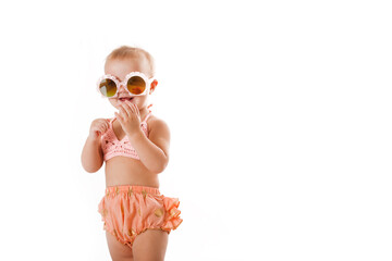Amusing funny baby Toddler in bathing suit and sunglasses, isolate on white. concept of travel with...
