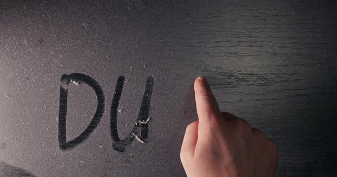 Dust on a table surface with inscription