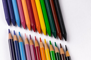 High angle close up shot of crayons and pencil colors shot on white surface -Art and Education concept.
