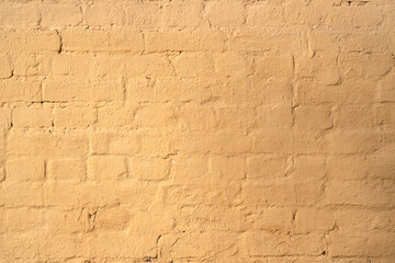 Old rough yellow brick wall texture. Background