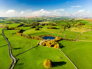 Aerial view of endless lush pastures and farmlands of England. Beautiful English countryside with...