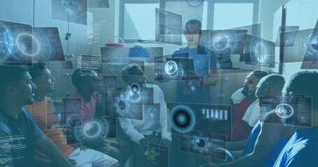 Digital interfaces with data processing against male coach instructing team of male soccer players - Powered by Adobe