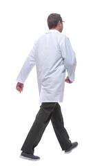 rear view. male doctor with a stethoscope striding away.