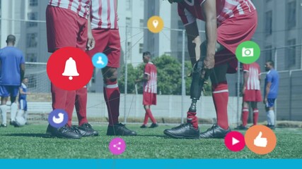 Network of digital icons against mid section of male soccer layer adjusting his prosthetic leg - Powered by Adobe