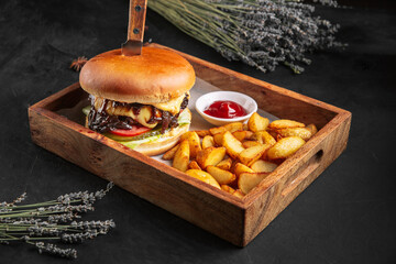 Beef meat burger set with fries and ketchup on the wooden board