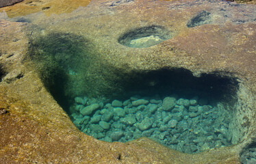 Gran Canaria, calm natural seawater pools in under the steep cliffs of the north coast, separated from the ocean by 
volcanic rock, Punta de Galdar area