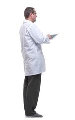 Naklejka na ściany i meble side view. doctor with a stethoscope using a digital tablet.