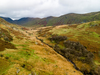 Aerial sunset view of the Lake District, famous for its glacial ribbon lakes and rugged mountains. Popular vacation destination in Cumbria, North West England.