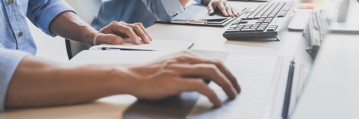 Programming developing software application. programmer writing program code with two monitors and working hacker on a new software