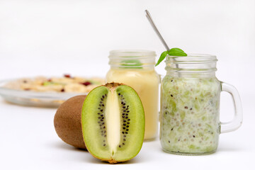 healthy breakfast kiwi and bottles with fruit smoothies and muesli in the background