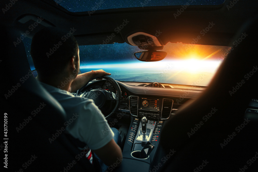 Poster Man sits in a spaceship car and flies to the planet with a sunset in space. Space travel by car, concept. Driver behind the wheel. Interplanetary taxi in space, creative idea