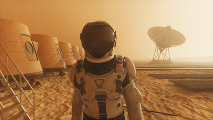 Astronaut on the planet Mars, making a detour around his base. Astronaut walking along the base. Small dust storm. The satellite dish sends data to the ground. 3D illustration