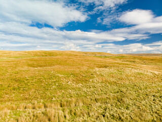 Aerial view of fields of dry grass in Yorkshire Dales National Park in northern England, UK