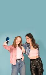 two friends girls taking selfie with smartphone 