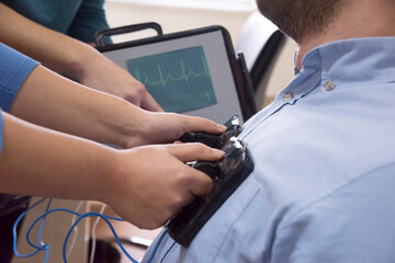 Genetics and Bioengineering classroom, teacher and students at an international school. The teacher is instructing the students on using  electric medical equipments.