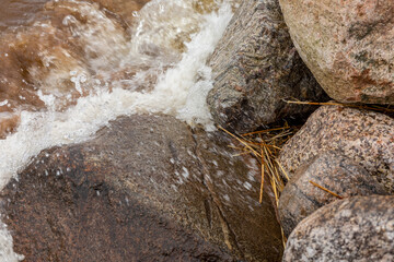 Sea splatters on the rocks in close up.