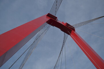 Obraz premium Red suspension bridge over sky