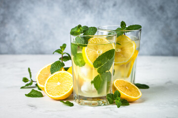 Lemonad in the glass at white table.
