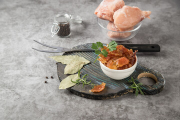 Dried chicken meat in a plate on a round wooden cutting board. The concept of long-term storage of products