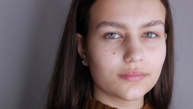 Beautiful girl model without makeup posing in front of the camera. Youth and health