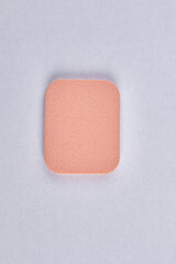 Top view of face powder sponge isolated on white background.