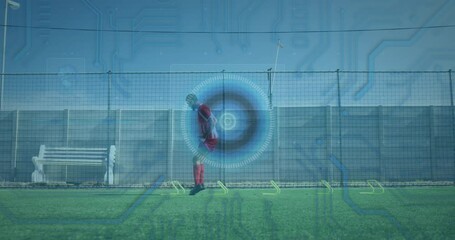 Microprocessor connections and round scanner against male soccer player practicing on grass turf - Powered by Adobe