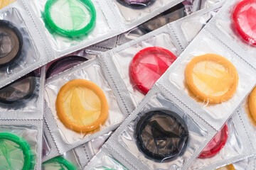 Colorful condoms background. - obrazy, fototapety, plakaty