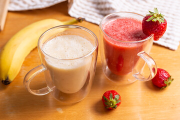 Strawberry and banana smoothie in glass glasses