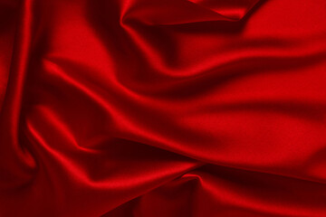 Red silk or satin luxury fabric texture can use as abstract background. Top view.