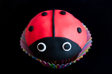 Cupcake ladybug homemade, close up, black background