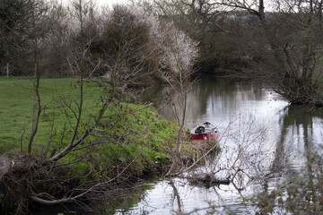 Walking on the Ouse way, Barcombe Mills, England, a small boat moored on the bank