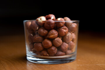 Hazelnuts in a clear glass on a table