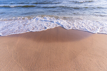Soft wave of blue ocean on sandy beach. Background, abstract background