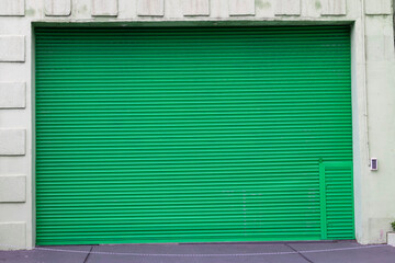 Fototapeta na wymiar large closed green gate of the garage