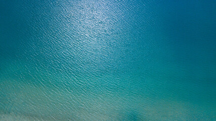 Fototapeta na wymiar Top view from drone of blue sea in sunny day