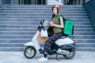 Food delivery service, female rider on motorbike delivering food to clients with scooter. Concepts about fast transportation, food delivery and technology.